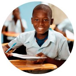 A smiling African boy holding a pencil and paper